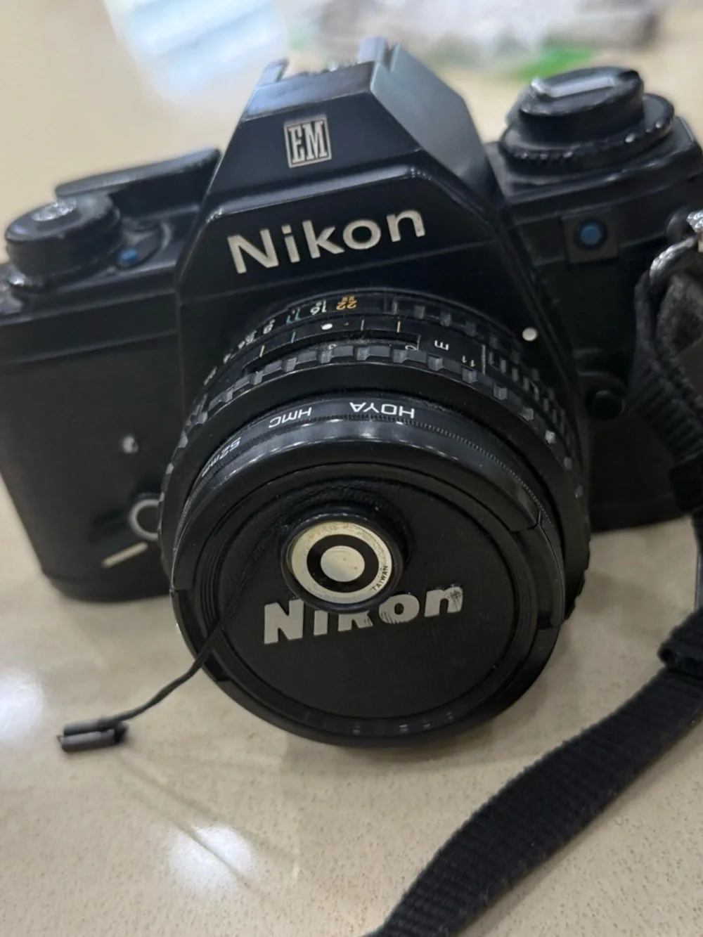 Nikon Black 35mm SLR Camera with Attached Lens and Strap